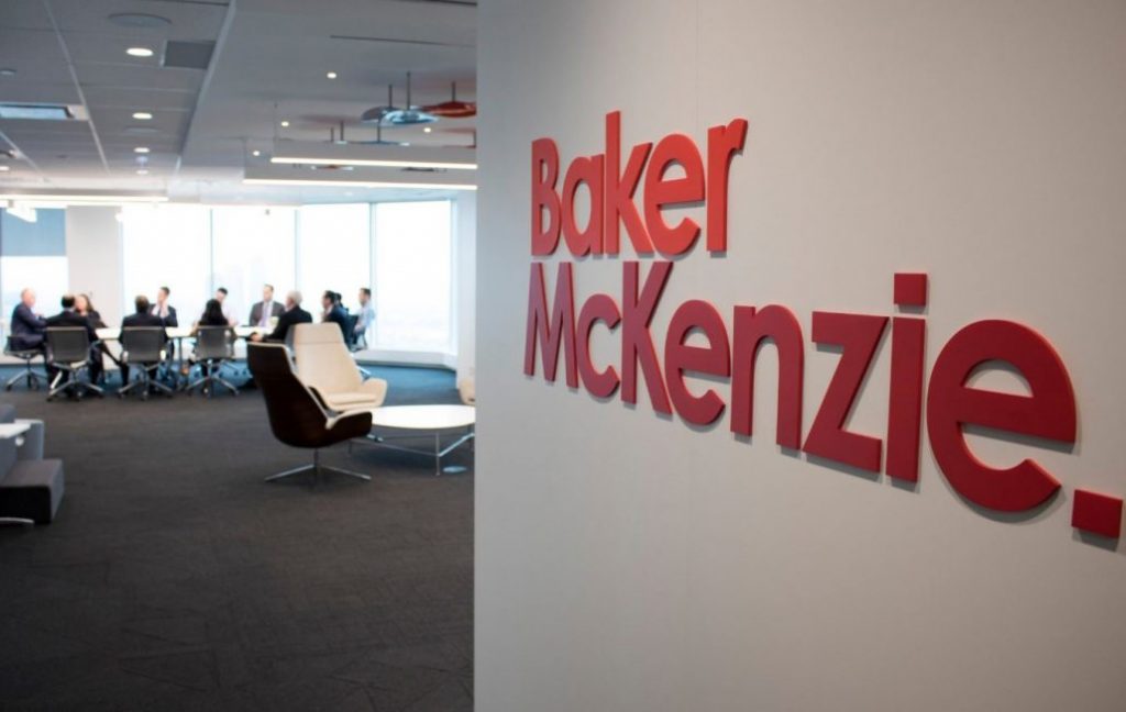 A picture of the Baker McKenzie office with the title of the firm on the wall