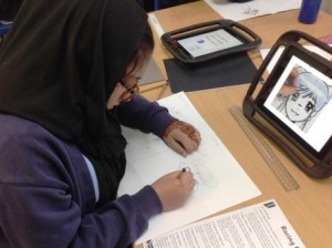 Image of Year 6 pupil researching Manga artform on iPad.