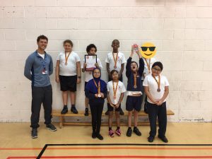 Image of Eight pupils are standing with their teacher in their sports kit wearing panathlon medals.