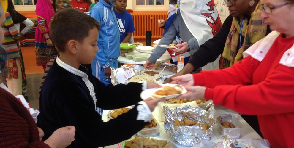 IMage of children being served a variety of food on their school International Day