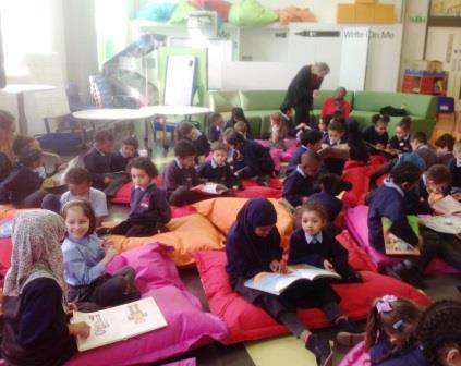 image of pupils on bean bags reading books together