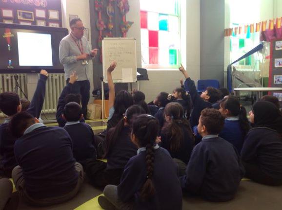 Image of author Christopher William Hill talking to Year 3 pupils about writing a story 